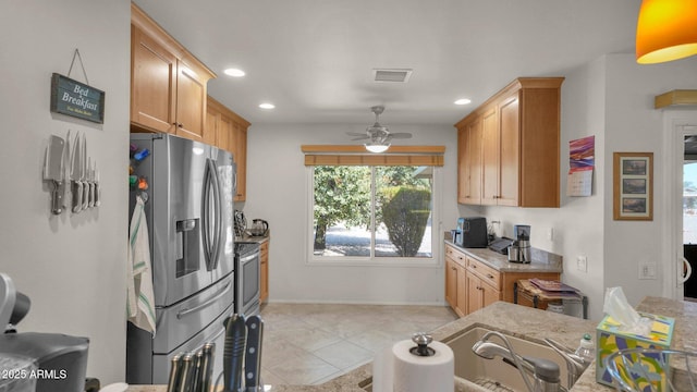 kitchen featuring recessed lighting, visible vents, a ceiling fan, stainless steel fridge with ice dispenser, and light stone countertops