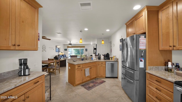 kitchen featuring light stone counters, appliances with stainless steel finishes, visible vents, and pendant lighting