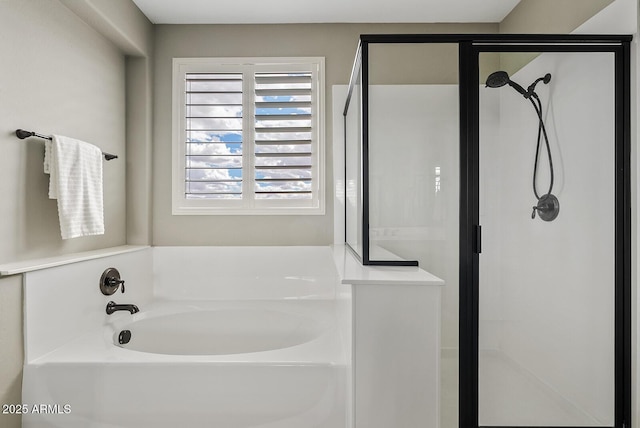 bathroom featuring a bath and a stall shower