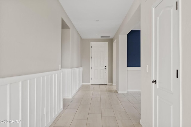 corridor featuring visible vents and baseboards