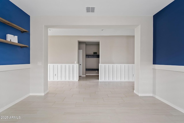 unfurnished room featuring visible vents and baseboards