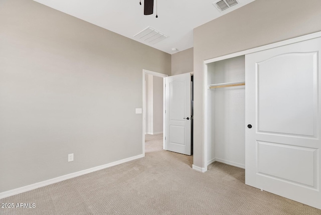 unfurnished bedroom with visible vents, baseboards, light carpet, a closet, and a ceiling fan