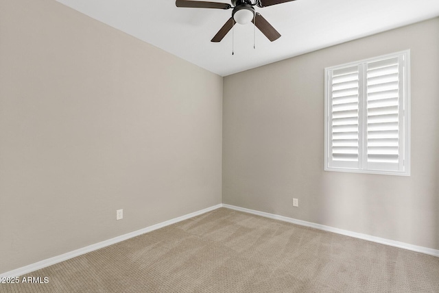 unfurnished room featuring baseboards, light carpet, and ceiling fan