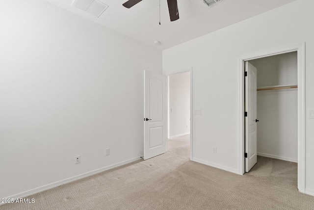 unfurnished bedroom with visible vents, baseboards, ceiling fan, light colored carpet, and a closet