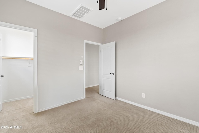 unfurnished bedroom with visible vents, baseboards, ceiling fan, light colored carpet, and a closet