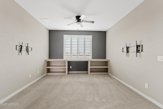 empty room featuring visible vents, baseboards, carpet, and a ceiling fan