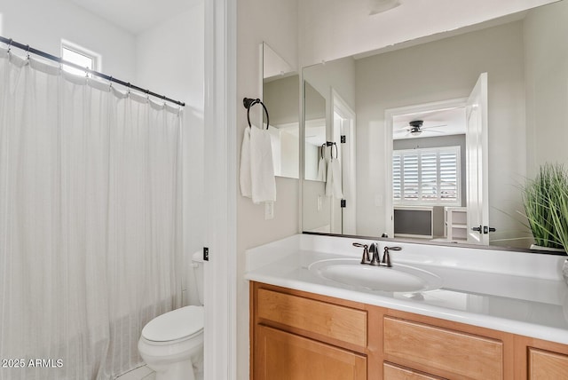 bathroom with vanity, a shower with shower curtain, toilet, and ceiling fan