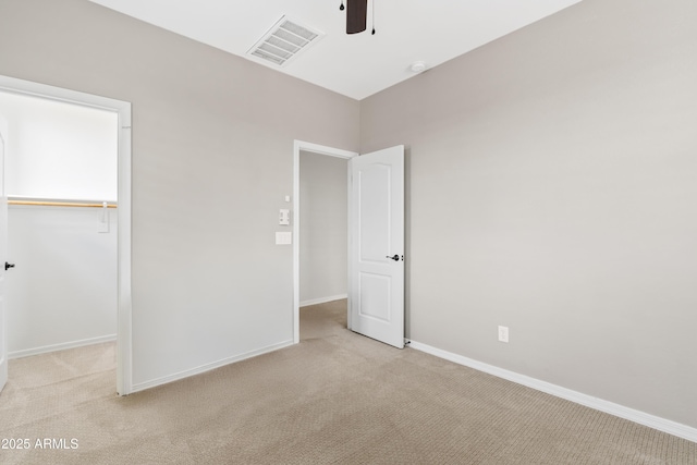 unfurnished bedroom with visible vents, ceiling fan, baseboards, light carpet, and a closet