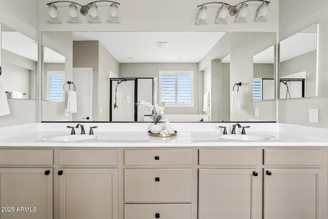 full bathroom featuring a shower stall, double vanity, and a sink