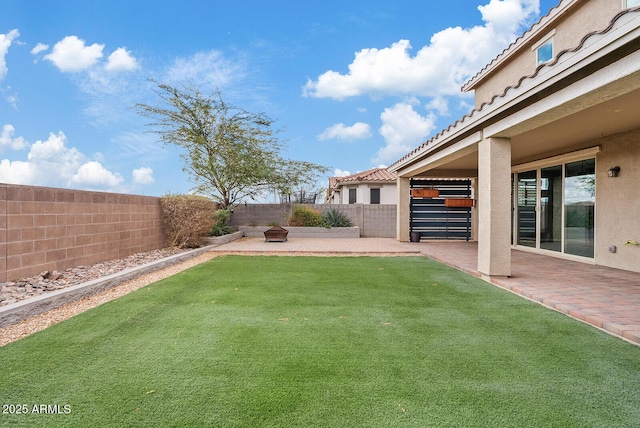 view of yard featuring a patio area and a fenced backyard