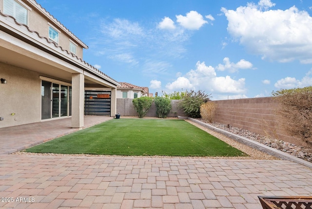 view of yard featuring a patio area and a fenced backyard