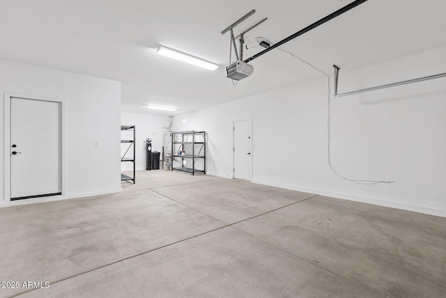 garage featuring baseboards and a garage door opener