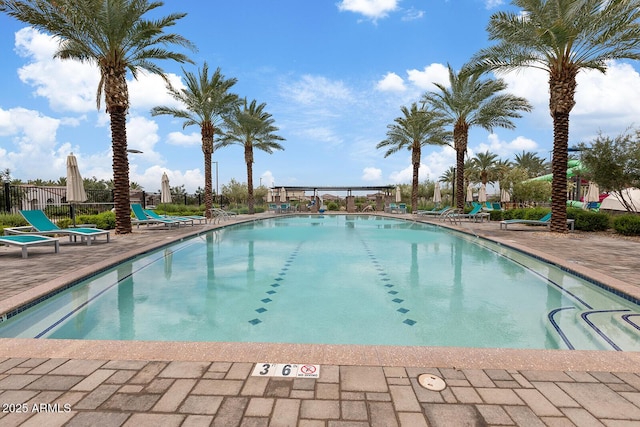 community pool featuring a patio and fence