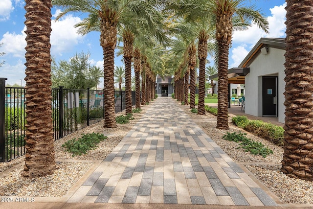 view of home's community featuring fence