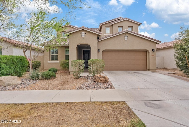 mediterranean / spanish-style house featuring a tile roof, an attached garage, driveway, and stucco siding