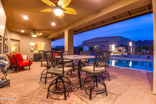 view of patio / terrace featuring ceiling fan, outdoor dining area, and fence