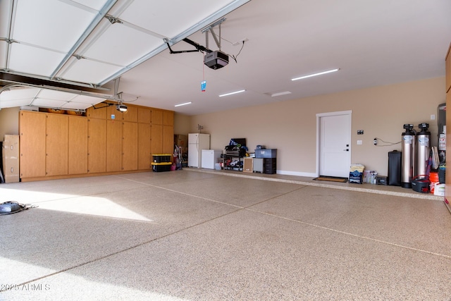 garage with freestanding refrigerator and a garage door opener