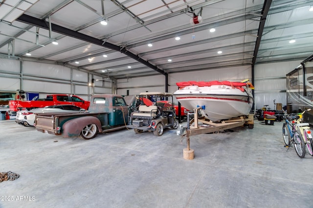 garage featuring metal wall and a garage door opener