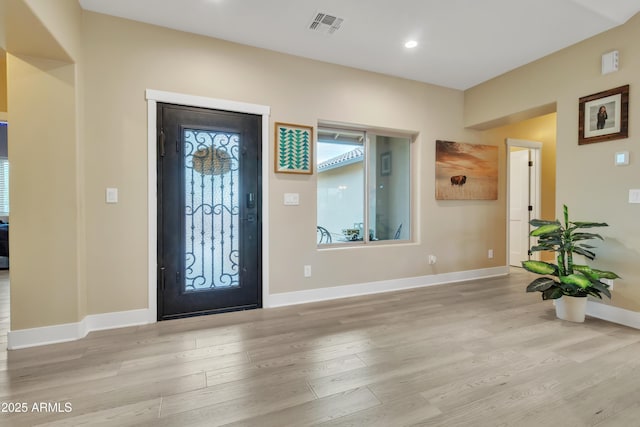 foyer with recessed lighting, visible vents, baseboards, and wood finished floors