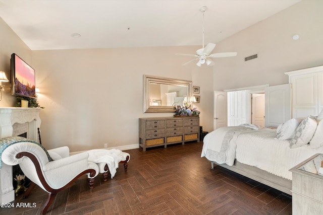 bedroom featuring dark parquet flooring, ceiling fan, and high vaulted ceiling