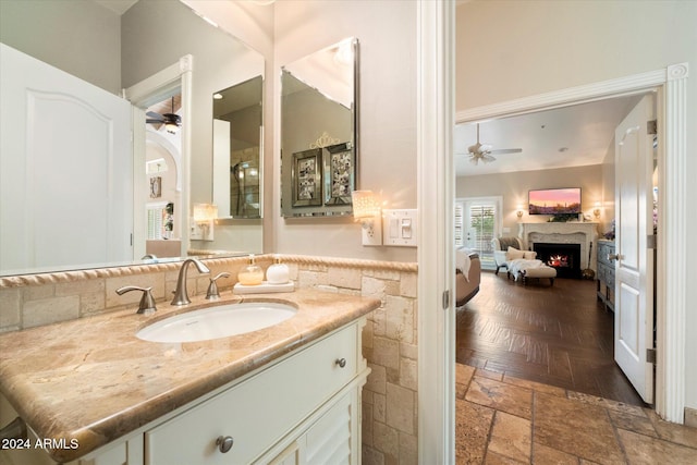 bathroom with parquet floors, ceiling fan, and vanity