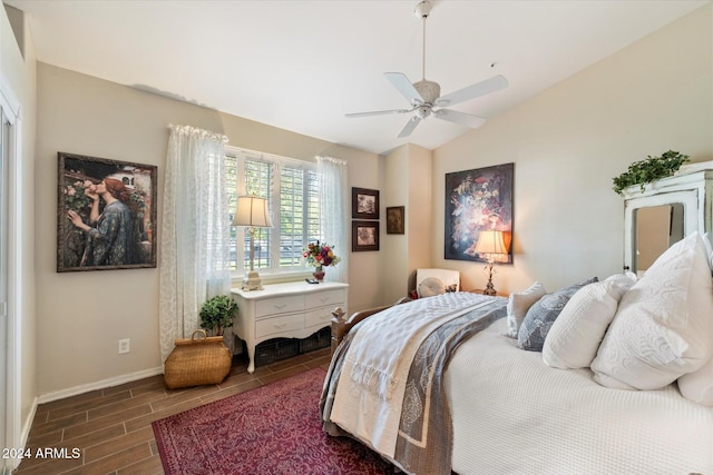 bedroom featuring dark hardwood / wood-style floors, ceiling fan, and lofted ceiling