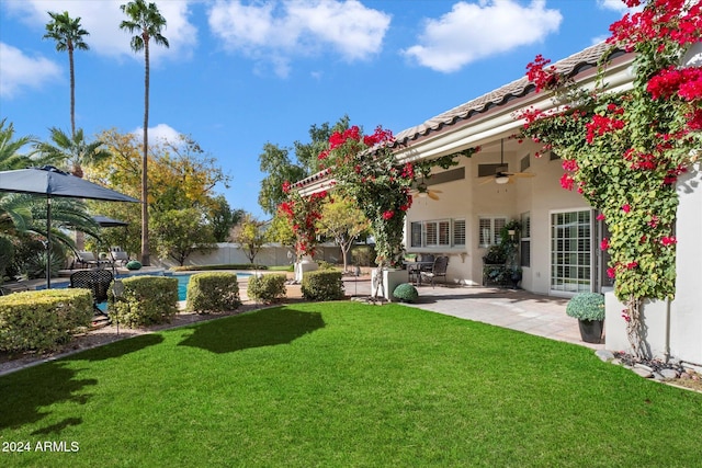 view of yard with a patio area and ceiling fan