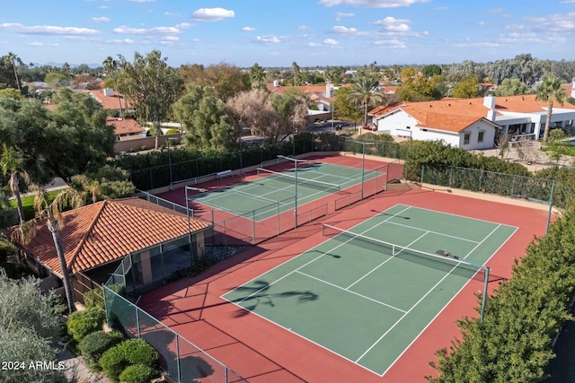 view of tennis court with basketball hoop