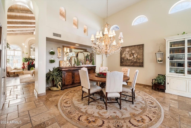 dining room featuring a high ceiling and an inviting chandelier