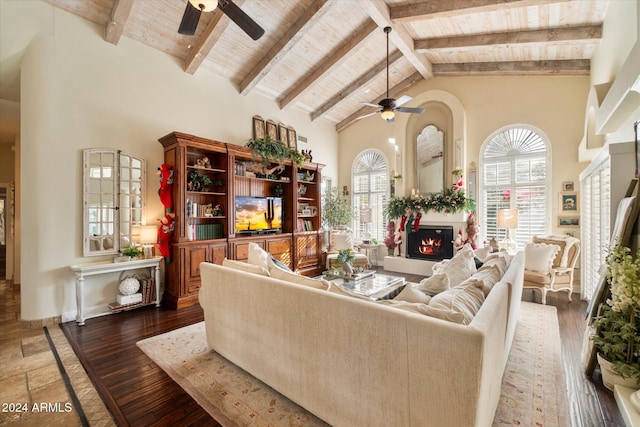 living room featuring hardwood / wood-style flooring, ceiling fan, beamed ceiling, and high vaulted ceiling