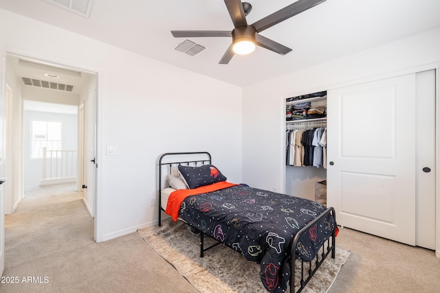 carpeted bedroom with ceiling fan and a closet