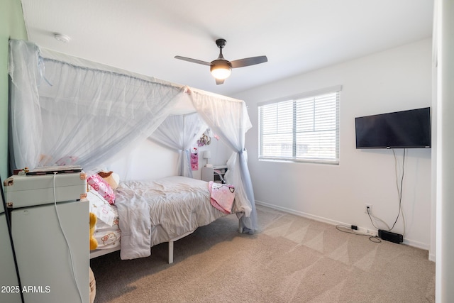 bedroom featuring light colored carpet and ceiling fan