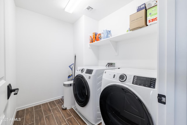 clothes washing area featuring washer and dryer