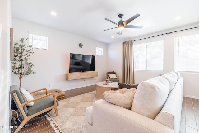 living room with ceiling fan and plenty of natural light