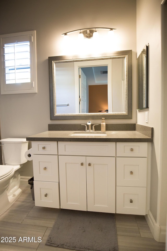 bathroom featuring toilet and vanity