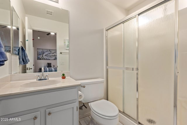 bathroom featuring walk in shower, vanity, and toilet