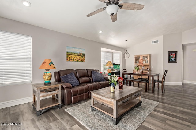 living room with lofted ceiling, dark hardwood / wood-style floors, and ceiling fan