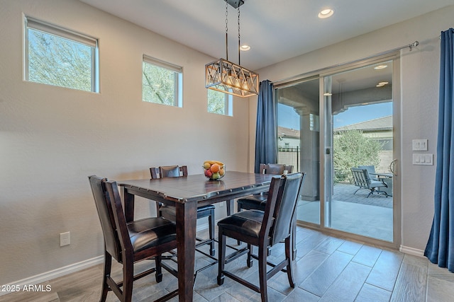 dining room featuring plenty of natural light, a chandelier, and light hardwood / wood-style flooring