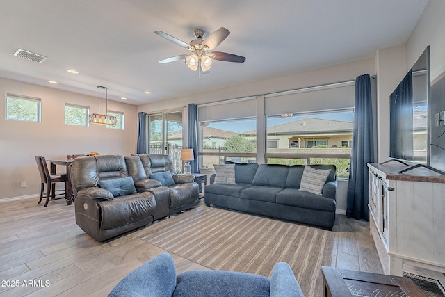 living room featuring ceiling fan and light wood-type flooring