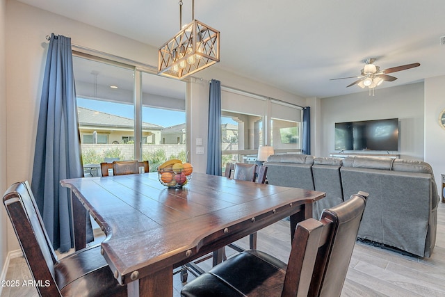 dining space with ceiling fan and light hardwood / wood-style floors