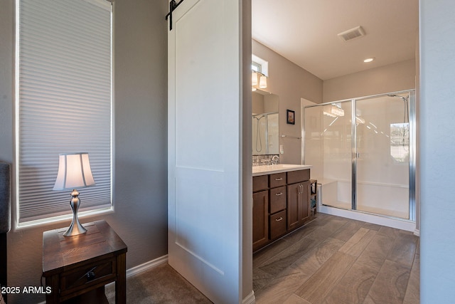 bathroom featuring vanity and a shower with shower door