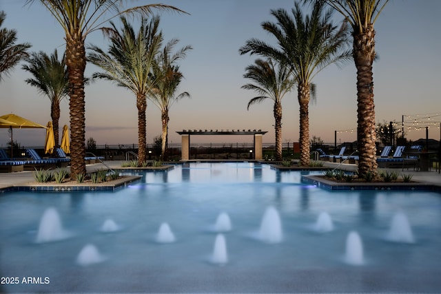 view of pool at dusk