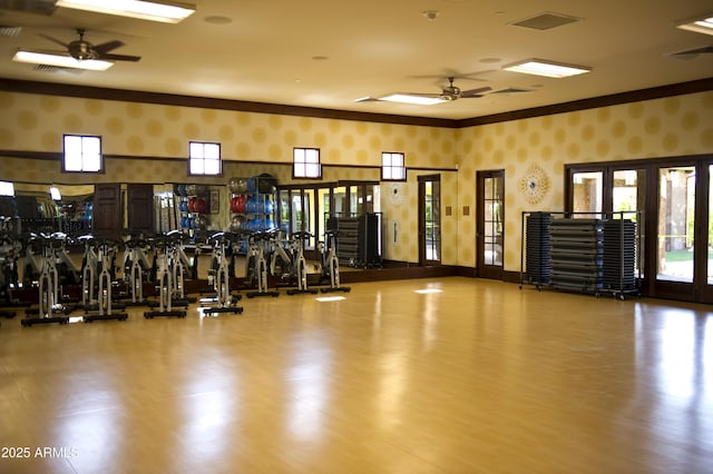 workout area with ceiling fan, hardwood / wood-style floors, and ornamental molding