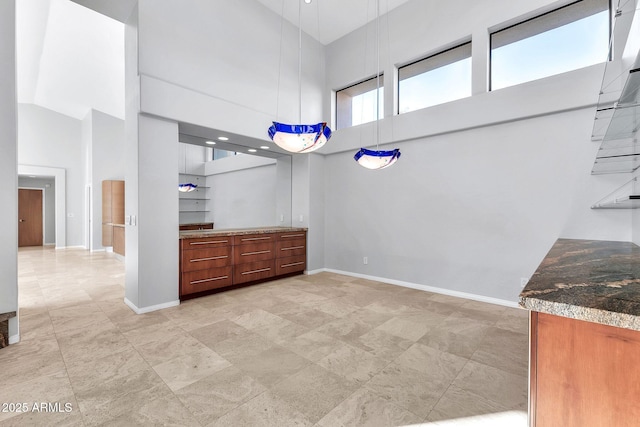 unfurnished dining area with a high ceiling