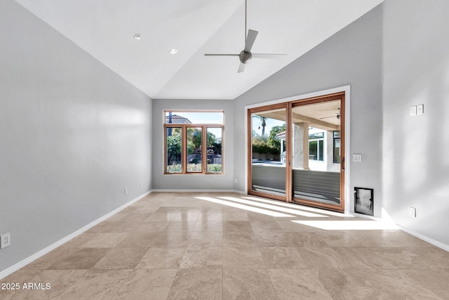 unfurnished room with ceiling fan and high vaulted ceiling