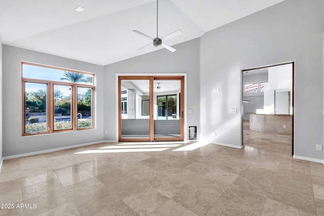 empty room with high vaulted ceiling and ceiling fan