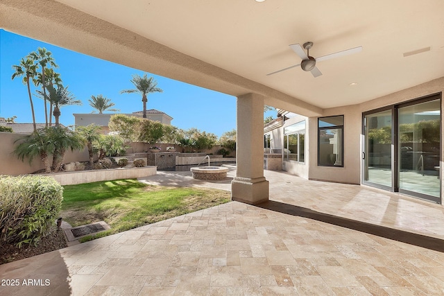 view of patio / terrace featuring ceiling fan and an outdoor fire pit