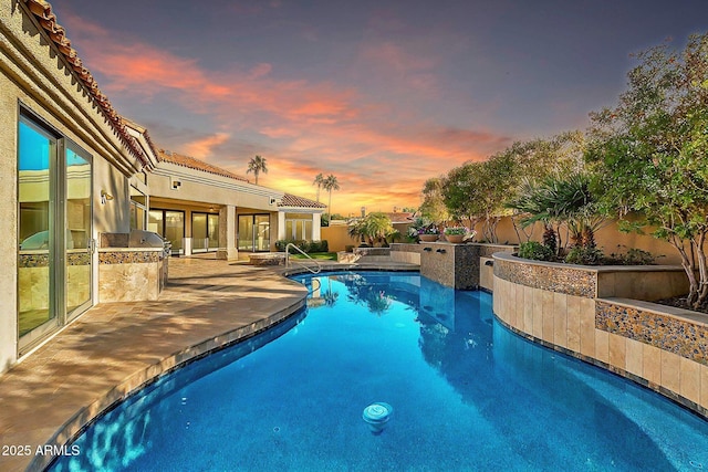 view of pool at dusk