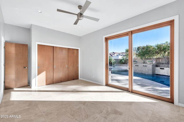 unfurnished bedroom featuring access to outside, a closet, and ceiling fan