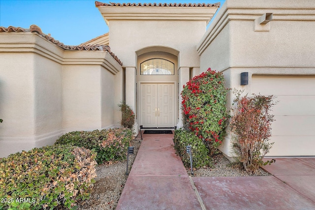 doorway to property with a garage